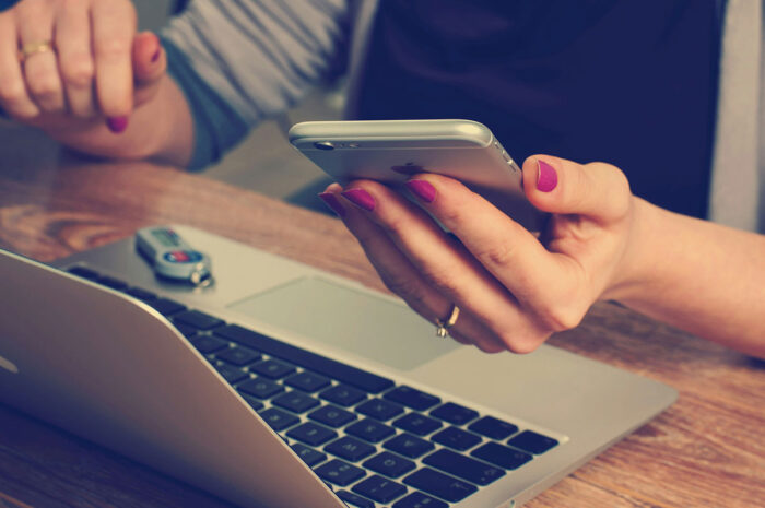 Person with laptop and phone contact Demex Group